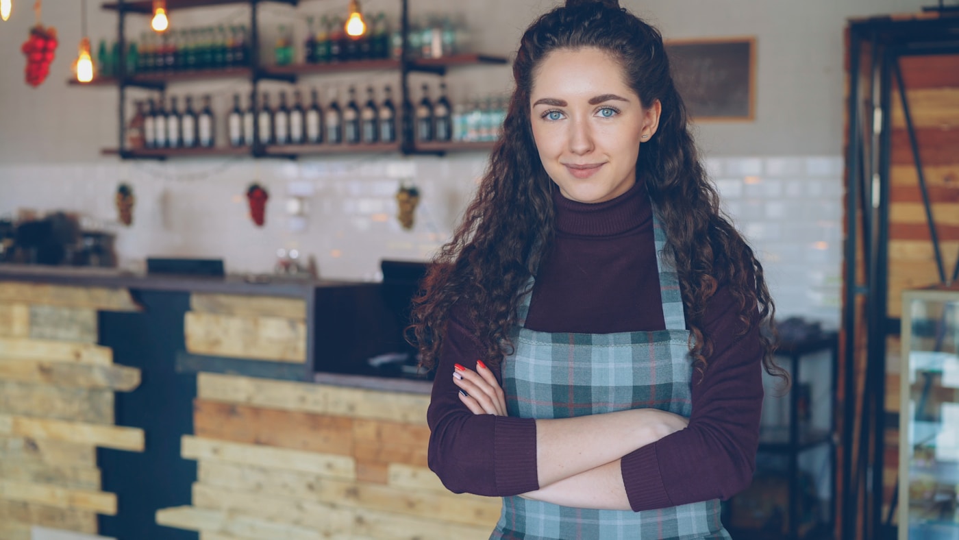 A small business owner standing in her café